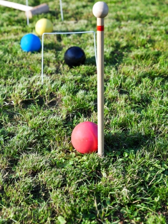 four balls on grass in game of croquet on green lawn in summer dayの写真素材