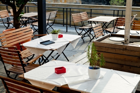 empty outdoor tables of waterfront restaurant in Berlin in autumnのeditorial素材