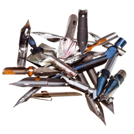 heap of used metal drawing pens isolated on white backgroundの写真素材