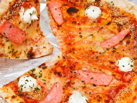 piece of italian pizza with salmon fish close upの写真素材