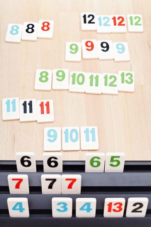 MOSCOW, RUSSIA - MARCH 17, 2014: playing desk of Rummikub board game. Rummikub was invented by Ephraim Hertzano in the early 1930s.のeditorial素材