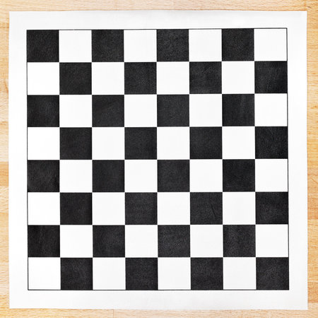 vinyl chessboard with black and white checks on wooden table