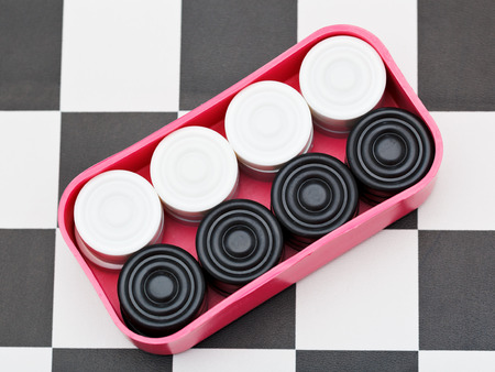 box with draughts on black and white checkerboardの写真素材