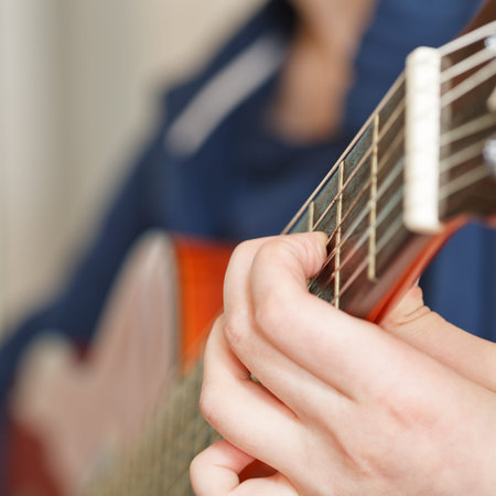 woman playing classical acoustic guitar close up