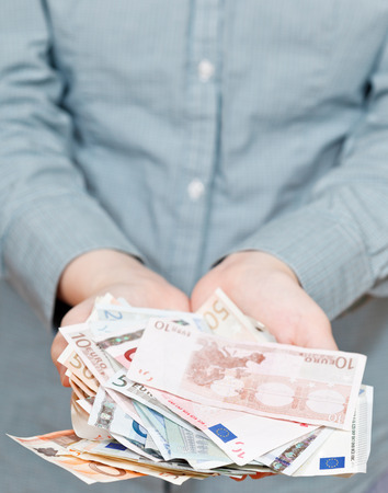 lot of euro banknotes in cupped palms close upの写真素材