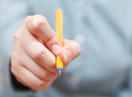 tip of pen close up in female handの写真素材
