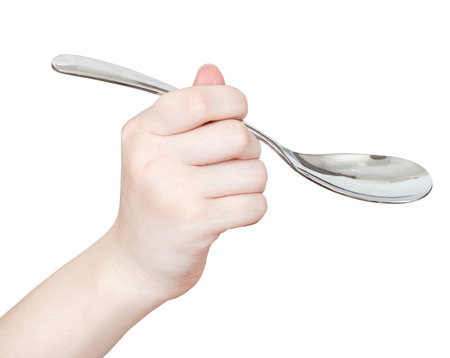 hand with soup spoon isolated on white backgroundの写真素材