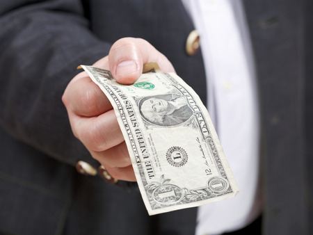 front view of one dollar banknote in businessman hand close up
