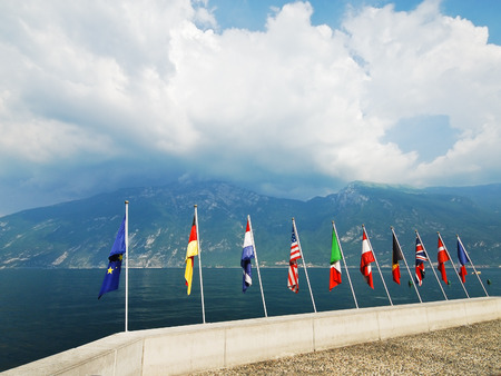 Flags of European countries over Garda lake, Italyの写真素材