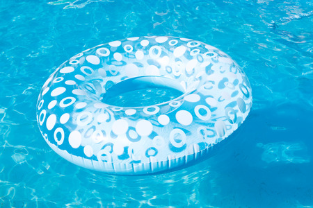 blue inflatable swimming circle in open air pool in summer dayの写真素材