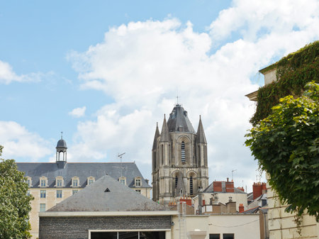 view of Saint-Aubin Tower over roof of urban houses in Angers city, France