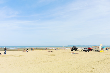 BLONVILLE SUR MER, FRANCE - AUGUST 5, 2014: people on sandy beach near village Blonville-sur-mer, France. Cote Fleurie is part of the Lower Normandy coast on the English Channel.のeditorial素材