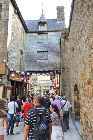 MONT SAINT-MICHEL, FRANCE - AUGUST 9, 2014: tourists in Mont Saint-Michel abbey. One of French recognisable landmarks, Mont Saint-Michel and its bay are in UNESCO list of World Heritage Sitesのeditorial素材