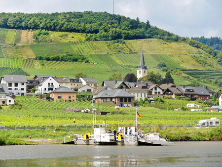 ELLENZ-POLTERSDORF, GERMANY - AUGUST 14, 2014: view of Ellenz Poltersdorf village from Moselle river, Germany. Village is winegrowing centre in Cochem-Zell district in Rhineland-Palatinate, Germanyのeditorial素材