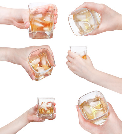 set of hand holds whiskey on ice in glass isolated on white backgroundの写真素材