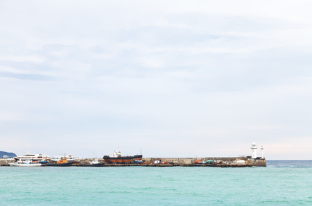 view of Black Sea and pier in Yalta city in autumn day, Crimeaの写真素材