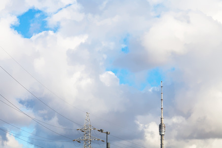 large white clouds over TV tower and power line in autumn dayの写真素材