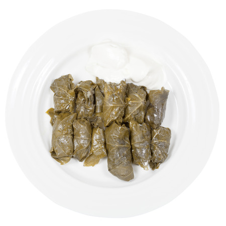top view of portion armenian meal - dolma from grape leaves and mince on plate isolated on white backgroundの写真素材