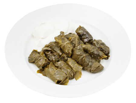 portion armenian meal - dolma from grape leaves and mince on plate isolated on white backgroundの写真素材