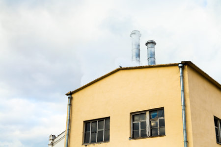 urban central heating station and smoke from chimneys in autumn dayの写真素材