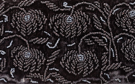 vintage embroidery by black beads on black velvet close up