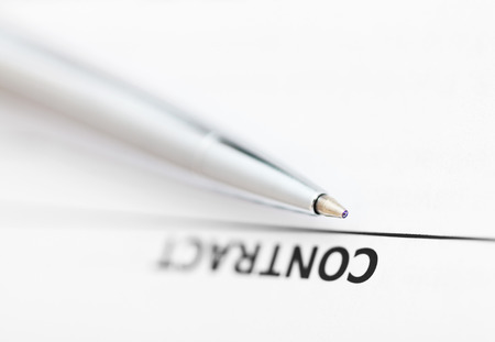 contract and tip of silver pen close upの写真素材
