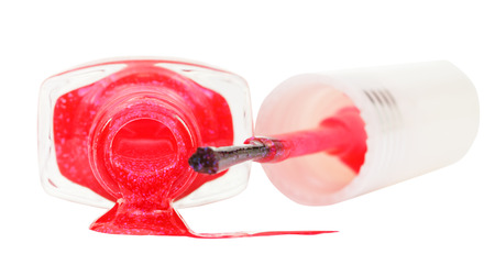 bottle with spilled pink nail polish isolated on white backgroundの写真素材