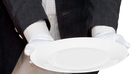 direct view of empty white plate in hands in white gloves isolated on white backgroundの写真素材