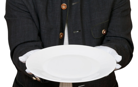 above view of empty white plate in hands in white gloves isolated on white backgroundの写真素材