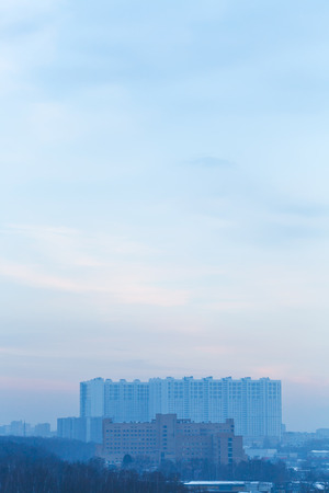twilight blue sky over urban houses in winter eveningの写真素材