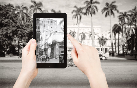 travel concept - tourist taking photo of urban squares in Havana city on mobile gadget, Cubaの写真素材