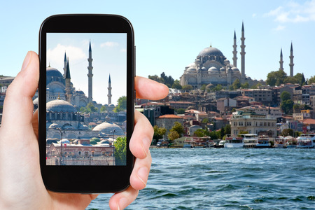 travel concept - tourist taking photo of Istanbul skyline on mobile gadget, Turkeyの写真素材