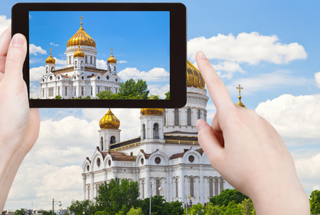 travel concept - tourist taking photo of Cathedral of Christ the Saviour, Moscow on mobile gadget, Russiaの写真素材