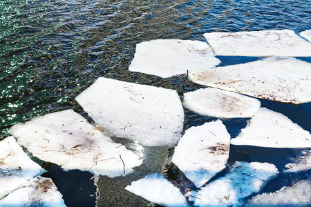 melting ice floes in river in sunny spring dayの写真素材
