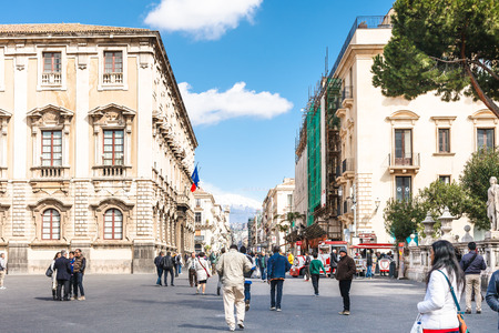 CATANIA, ITALY - APRIL 5, 2015: tourists at via Etnea and view Etna volcano in Catania, Sicily, Italy. Etnea is the main street of historical center of Catania, it is about three kilometers long.のeditorial素材