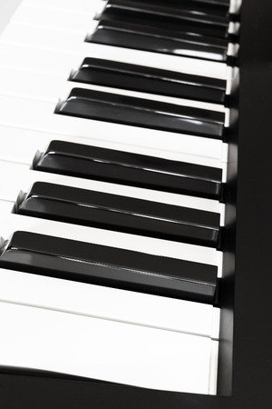 side view of black and white keys of musical digital keyboard close upの写真素材