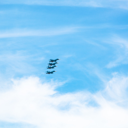 four green military fighter aircrafts in cloudy blue skyの写真素材