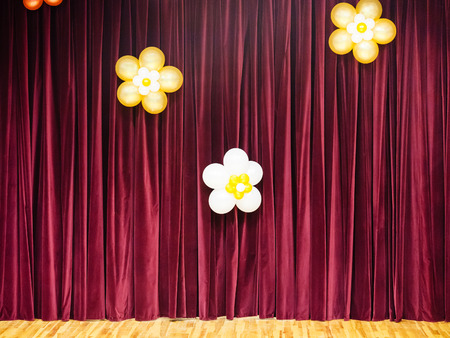 closed theater red curtains decorated by baloonsの写真素材