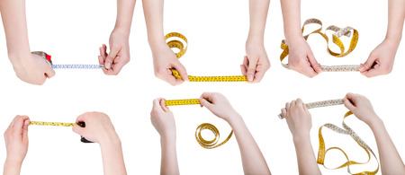 set of female hands with measuring tapes isolated on white backgroundの写真素材