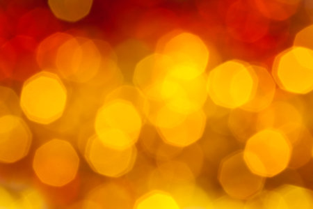 abstract blurred background - big yellow and red flickering Xmas lights of garlands on Christmas treeの写真素材