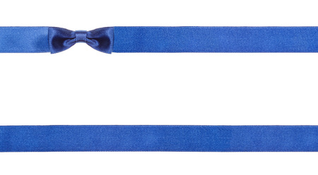 one blue satin bow knot in upper left corner and two horizontal ribbons isolated on horizontal white backgroundの写真素材