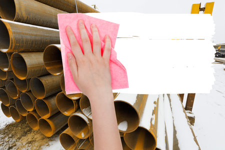 ecology concept - hand deletes industrial landscape by pink rag from image and white empty copy...