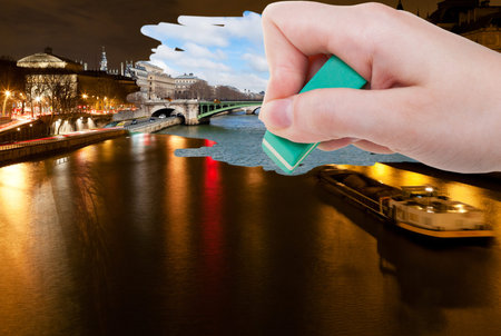 travel concept - hand deletes night scenery of Paris city by rubber eraser from image and day...