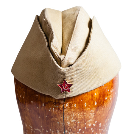 direct view of military khaki garrison cap with soviet red star sign on wooden dummy isolated on white background close upの写真素材