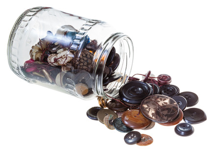 glass jar with sewing buttons isolated on white backgroundの写真素材