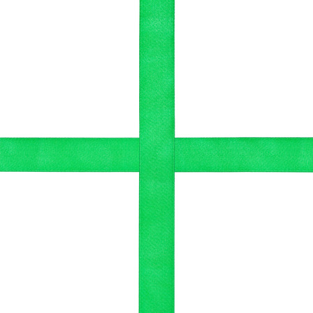 cross from green satin ribbons isolated on white backgroundの写真素材