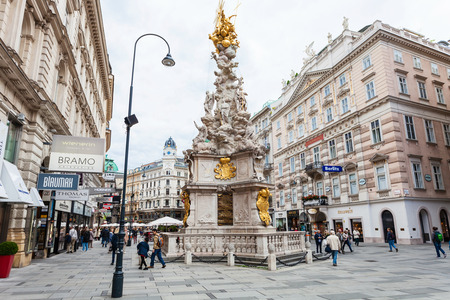 VIENNA, AUSTRIA - SEPTEMBER 27, 2015: monumental Plague column (Pestsaule) and tourists on Graben street. The Graben is one of the most famous streets in Vienna first district, the city centre.のeditorial素材