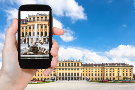 travel concept - tourist snapshot of fountain near Schloss Schonbrunn palace in Vienna on smartphoneのeditorial素材