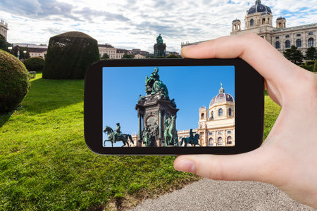 travel concept - tourist snapshot of Empress Maria Theresa statue on Maria Theresien square in Vienna on smartphoneのeditorial素材