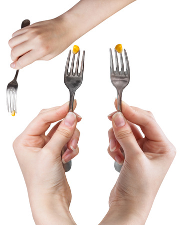 set of dinning forks with impaled yellow corn seed isolated on white backgroundの写真素材
